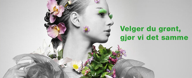 En kvinne avbildet i profil i svart/hvitt med fargerike blomster som pynt i håret og rundt halsen. Grønne øyenvipper. Tekst: Velger du grønt, gjør vi det samme