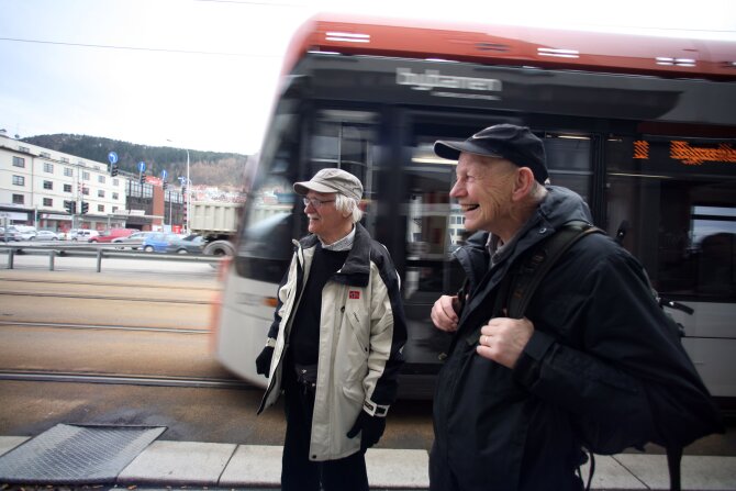 Happy passengers with the tram in the background