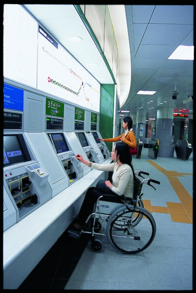 ticket machine easily used by a woman in wheelchair