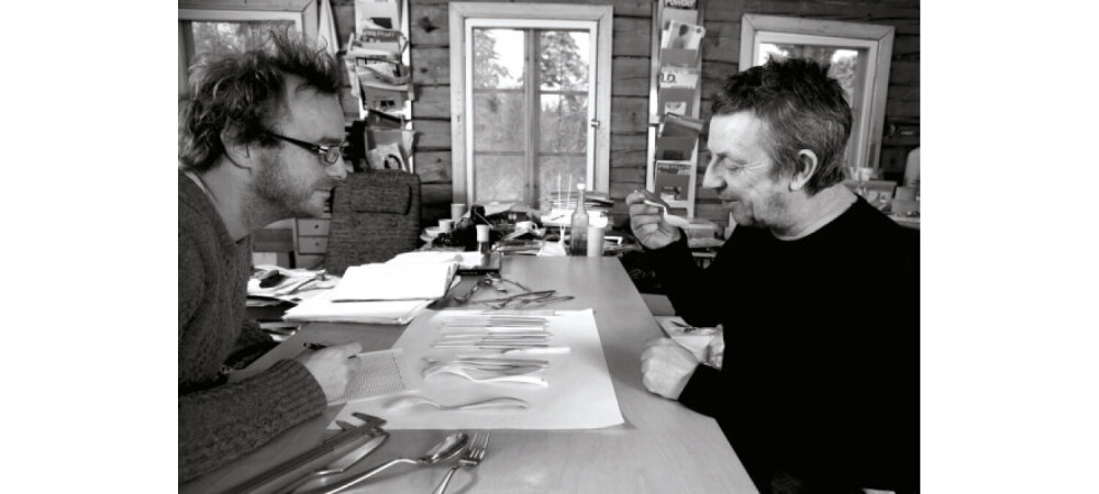 Two men evaluating cutlery