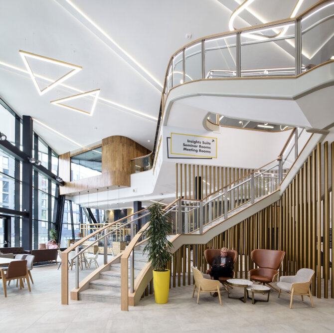 The open ground floor space features a dramatic staircase