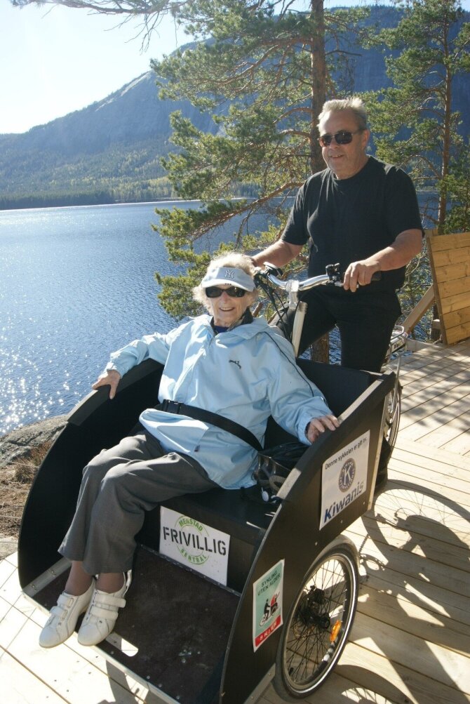 Senior lady sitting very satisfied on a bicycle taxi