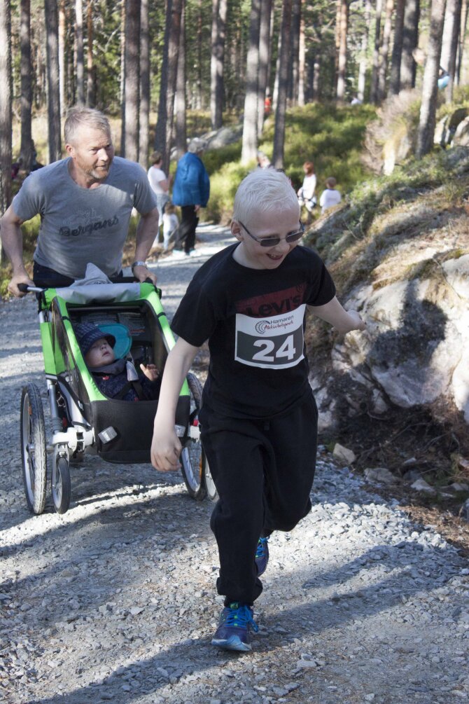 father with to kids participating in the local race